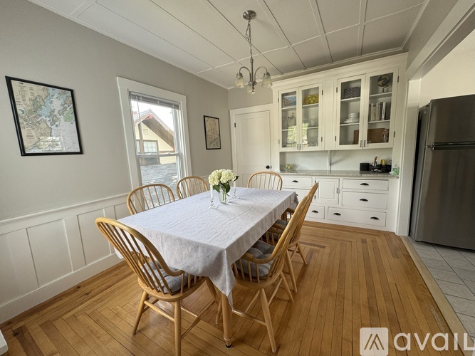 A dining room with a table set for four.