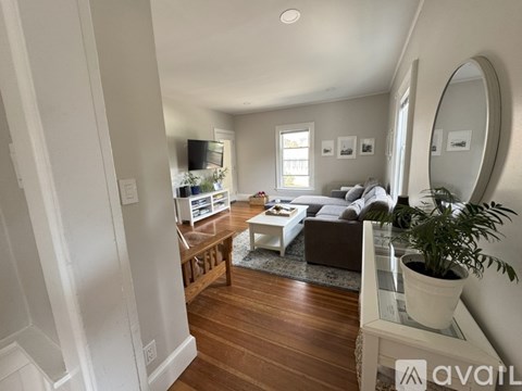 A living room with a white couch and a coffee table.
