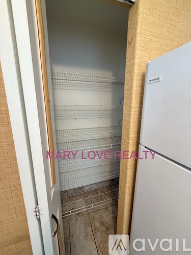 A refrigerator is in a kitchen with a door open.