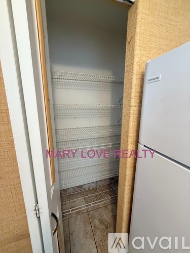 A refrigerator is in a kitchen with a door open.