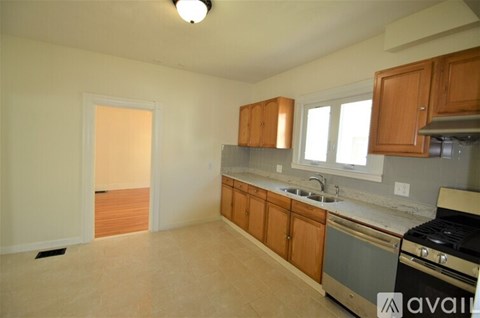 A kitchen with wooden cabinets and a black stove top oven.