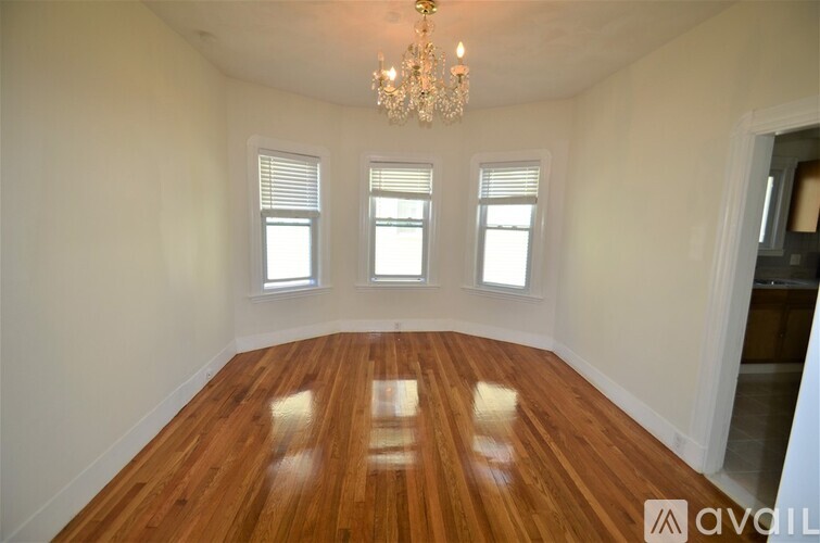 A room with wooden floors and a chandelier.
