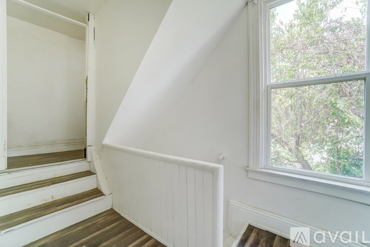 A white staircase with a window on the side.