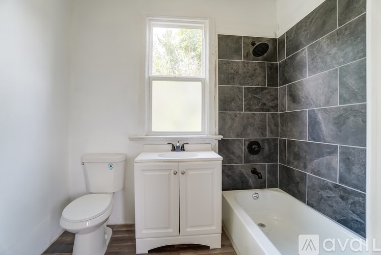 A bathroom with a toilet, sink, and bathtub.