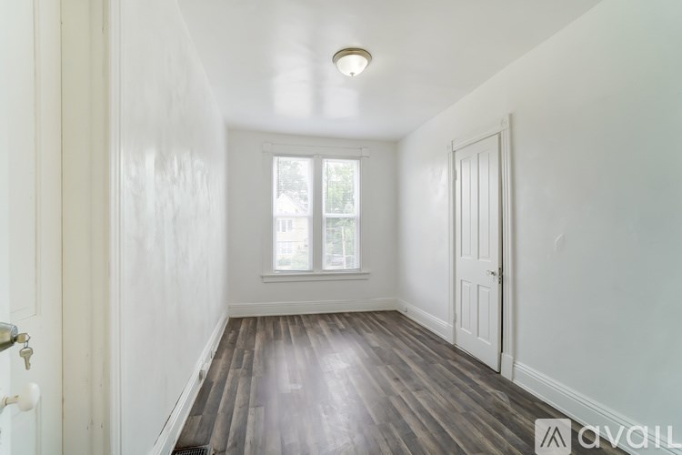 A room with a window and a door.