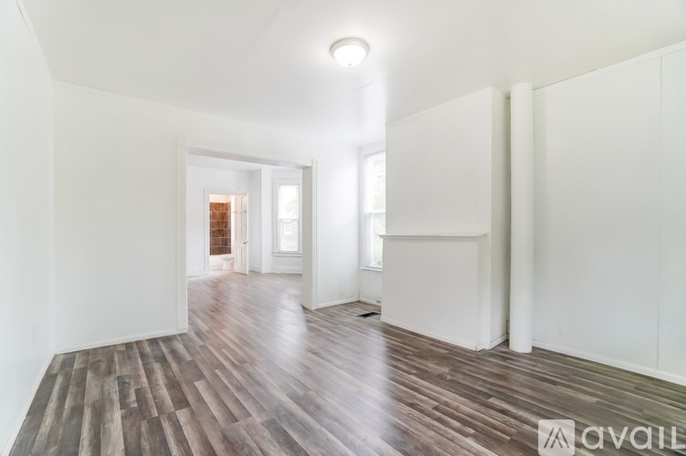 A room with wooden floors and white walls.