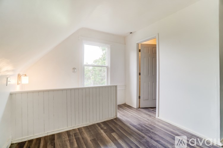 A room with wooden floors and white walls.