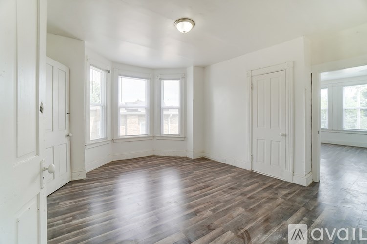 A room with wooden floors and white walls.