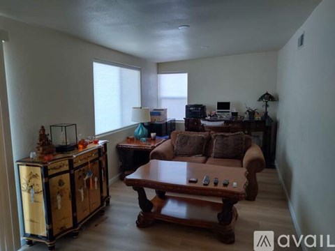 A living room with a brown couch and a wooden coffee table.