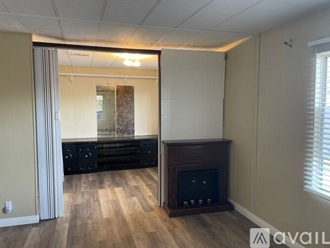 A room with a fireplace and a sliding glass door.