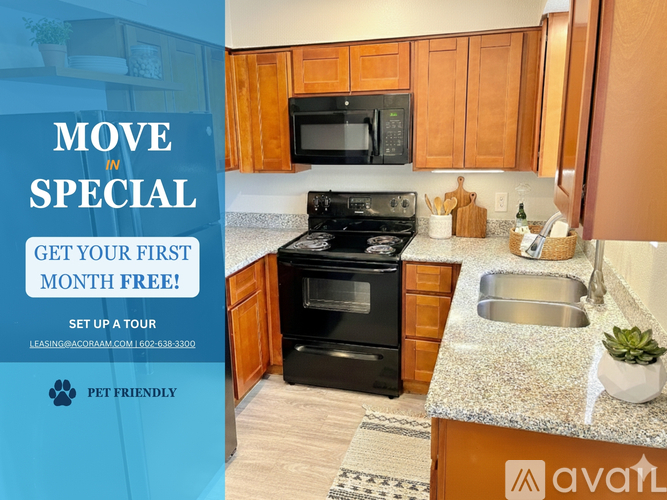 A kitchen with a refrigerator, microwave, and oven is on display for a move-in special.
