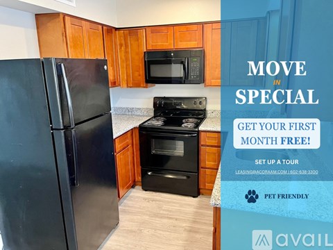 A kitchen with a refrigerator, microwave, and oven is on display for a move-in special.