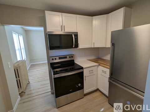 A kitchen with white cabinets and stainless steel appliances.