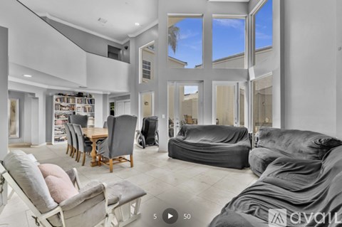 A living room with a grey sofa and a wooden table.