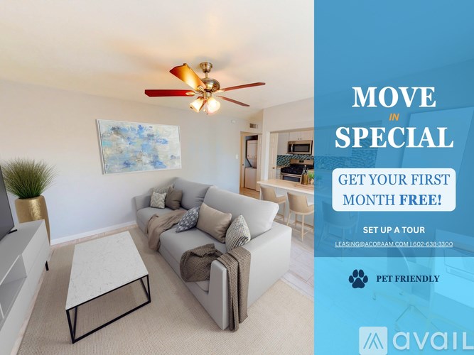 A living room with a couch, a coffee table, and a ceiling fan.