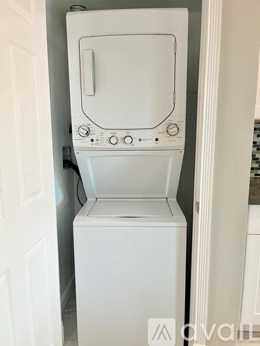 A white washing machine in a small room.