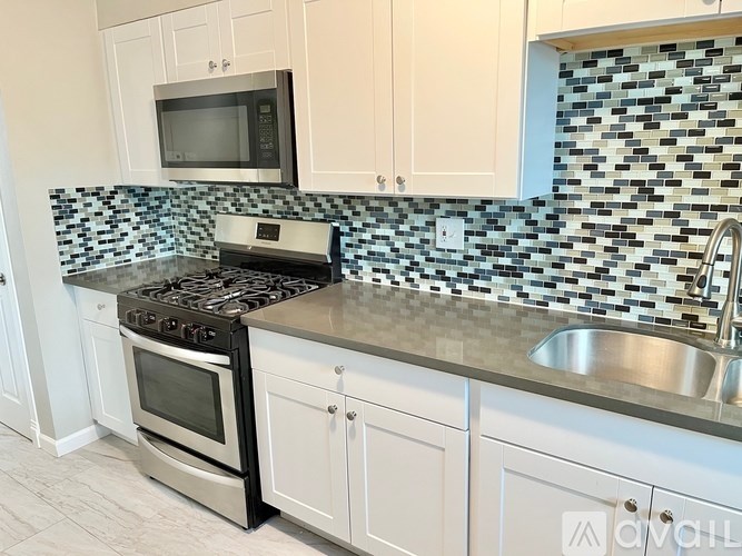 A kitchen with a black and white checkered backsplash.