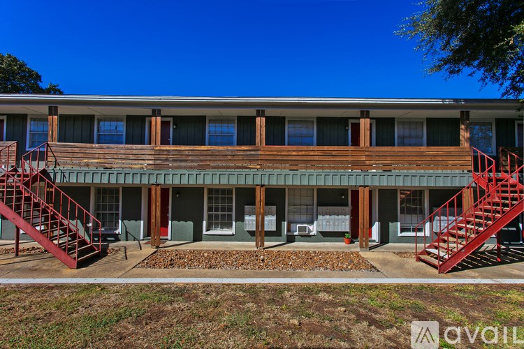 A building with a red staircase on the left and right side.