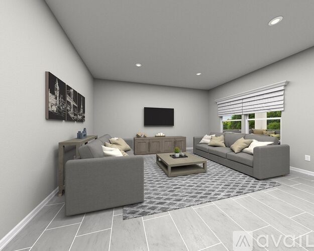 A modern living room with a grey sofa set and a coffee table.