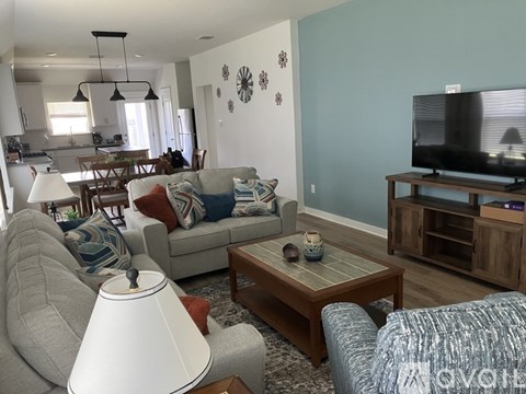 A living room with a grey couch and a wooden coffee table.