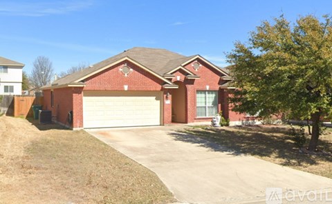 A red brick house with a white garage door.