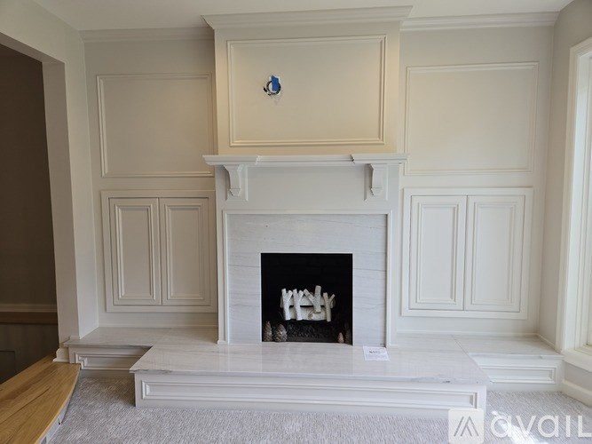 A white fireplace with a blue decoration above it.