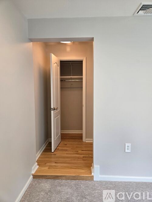 A hallway with a door at the end.