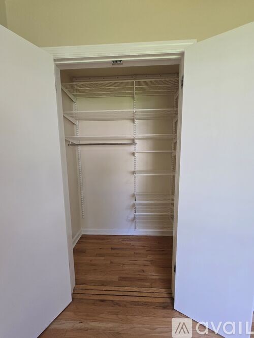 Empty room with white walls and wooden floor.
