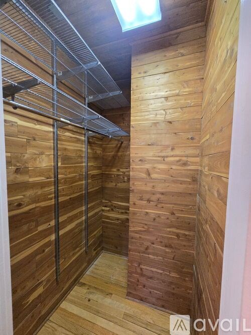 A wooden wall with a metal rack on top.