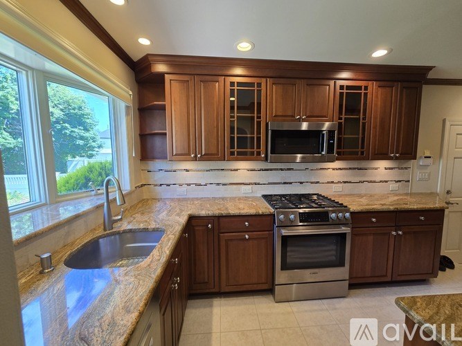 A kitchen with granite countertops and stainless steel appliances.