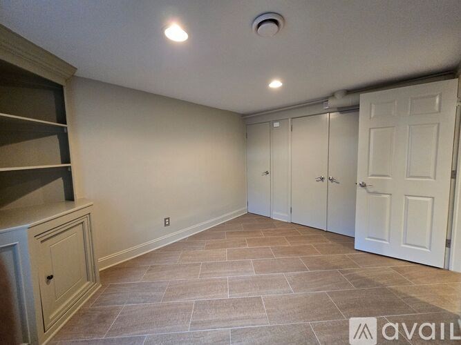 A room with a tiled floor and white walls.