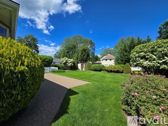 A well-manicured garden with a clear blue sky above.