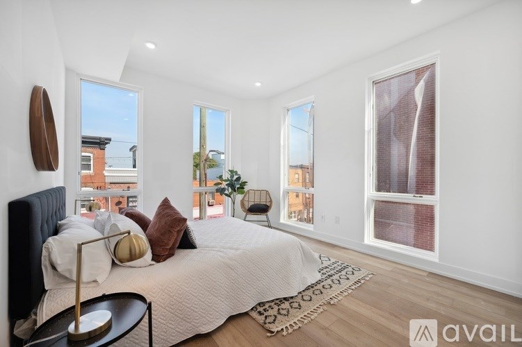 A bedroom with a large bed and a view of the city.