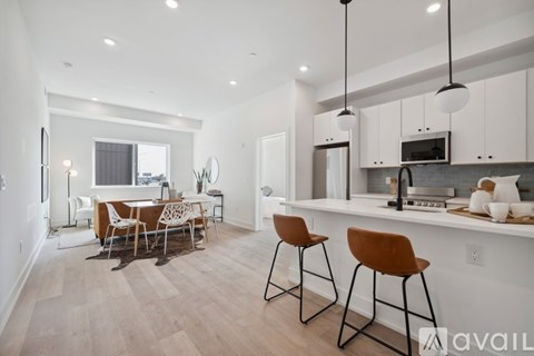 A modern kitchen with a dining table and chairs.