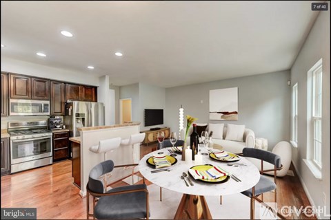 A modern dining room with a round table set for six.