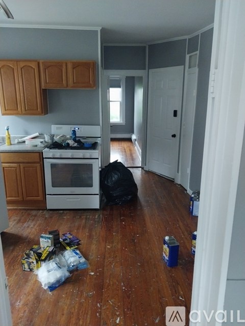 A kitchen with a white stove and wooden cabinets.