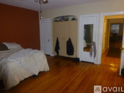 A bedroom with a bed, wardrobe and a window.