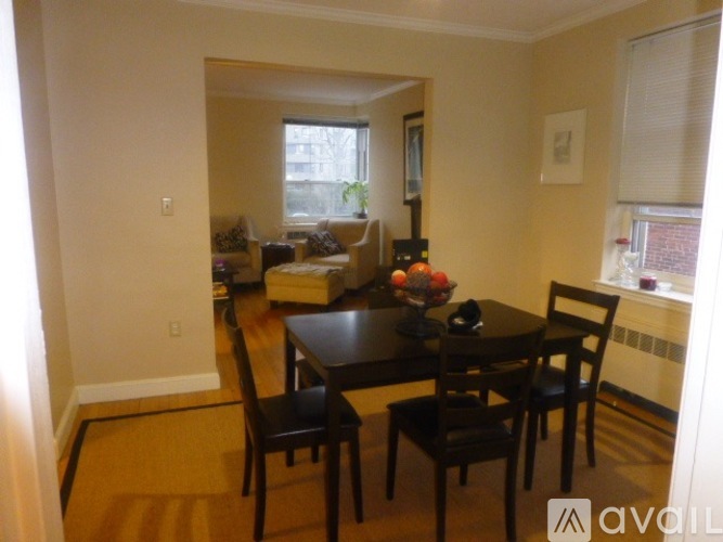 A dining room with a table and chairs.