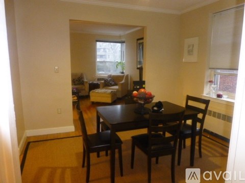 A dining room with a table and chairs.