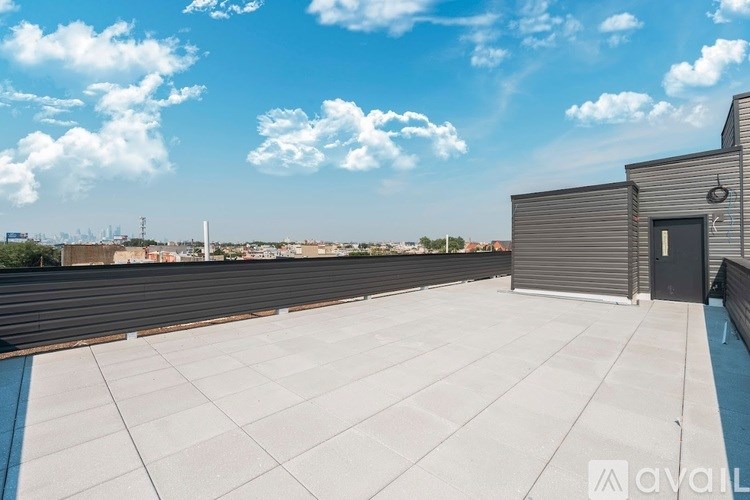 A rooftop with a closed garage door and a clear blue sky.
