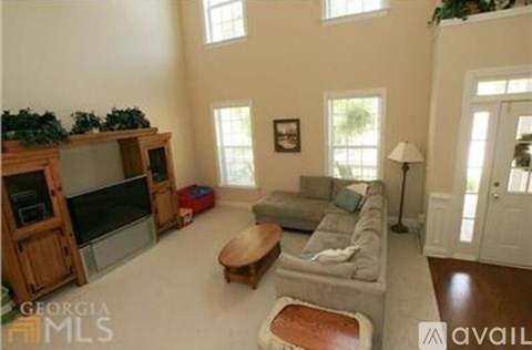 A living room with a grey couch and a wooden coffee table.