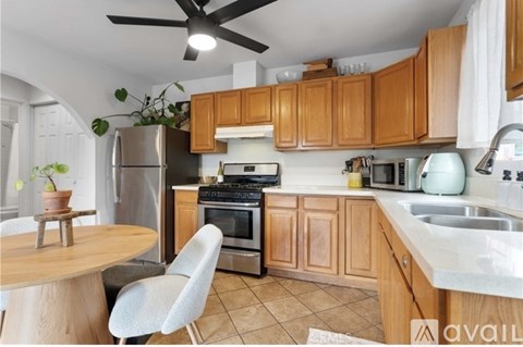 A kitchen with wooden cabinets and a white countertop.
