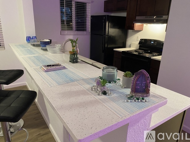 A kitchen with a table and chairs.