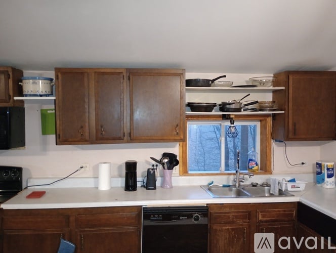 A kitchen with wooden cabinets and a white countertop.