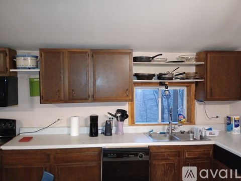 A kitchen with wooden cabinets and a white countertop.