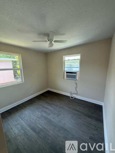 A room with a ceiling fan and a window.