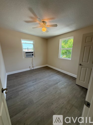 A room with a ceiling fan and a window.