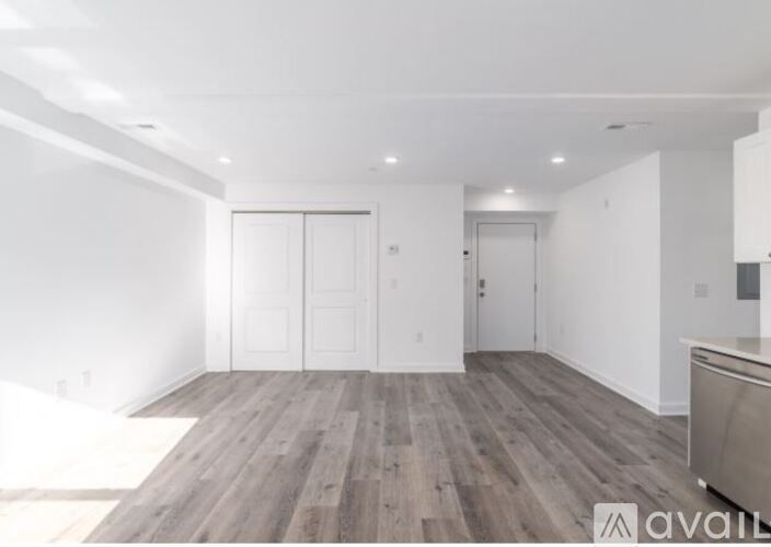 A room with wooden floors and white walls.