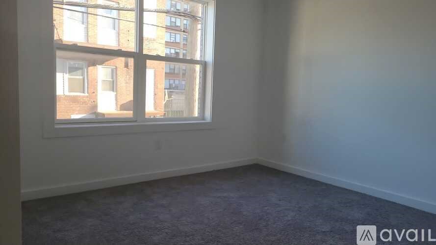 A room with a large window overlooking a city street.