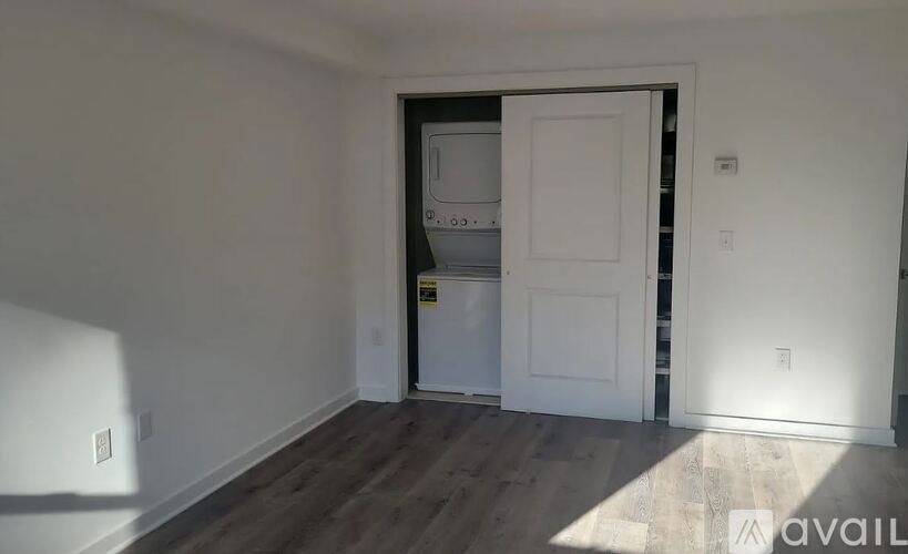 A room with a white door and a white wall.